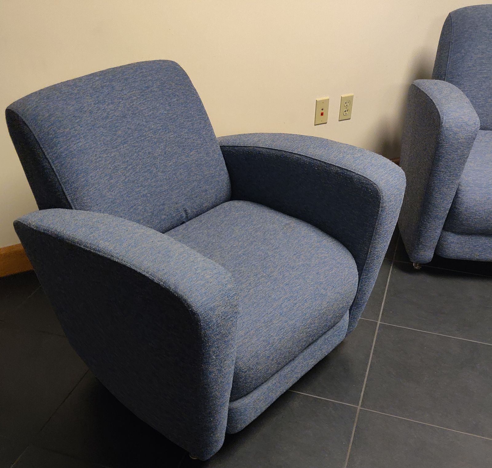 Pair of custom blue-grey upholstered lounge chairs for an office reception area
