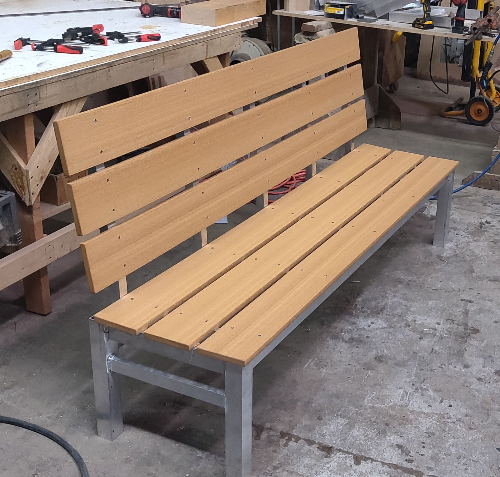 Wood-slat bench on a galvanized steel tube frame