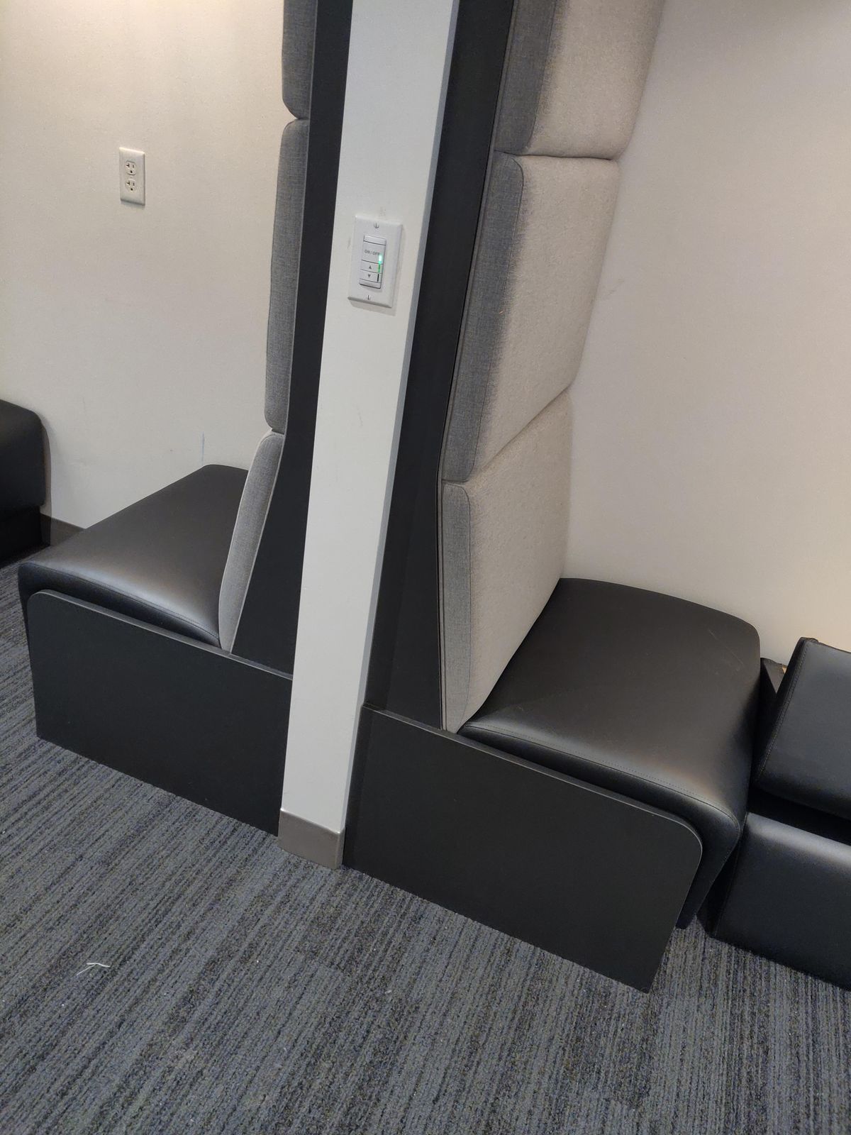 High-back back-to-back airport booth seating with tall acoustic panels